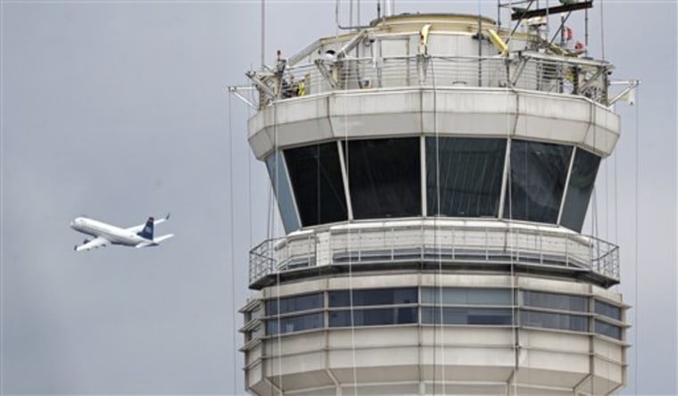 A passenger jet flies past the FAA control tower at Washington's Ronald Reagan National Airport. The Federal Aviation Administration agreed nearly two years ago with a government watchdog's recommendations that air traffic controllers' work schedules be changed to combat fatigue, but did not act on them. 